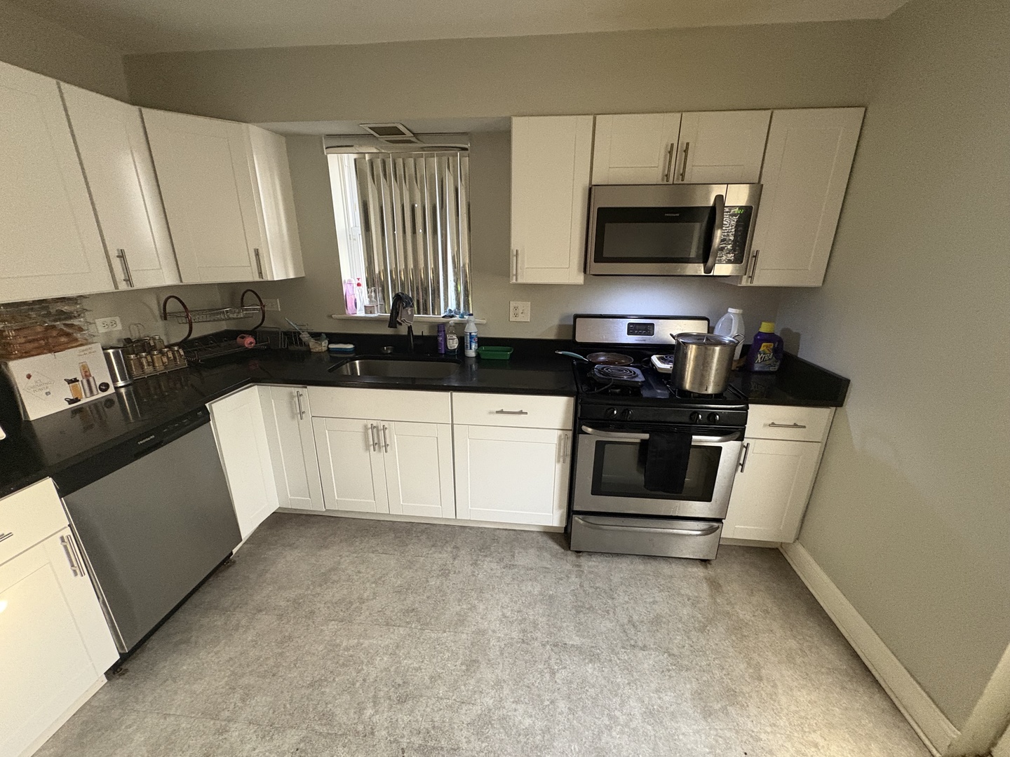 8118 South Spaulding Avenue Chicago, IL 60652 - Photo 3 of 13 a kitchen with granite countertop a sink a stove and microwave