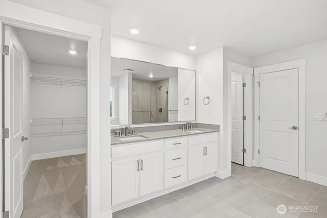 a spacious bathroom with a granite countertop sink mirror and a