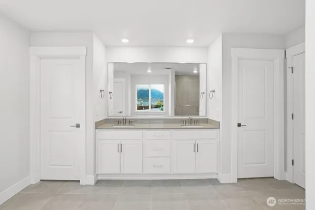 a bathroom with a granite countertop sink and a mirror