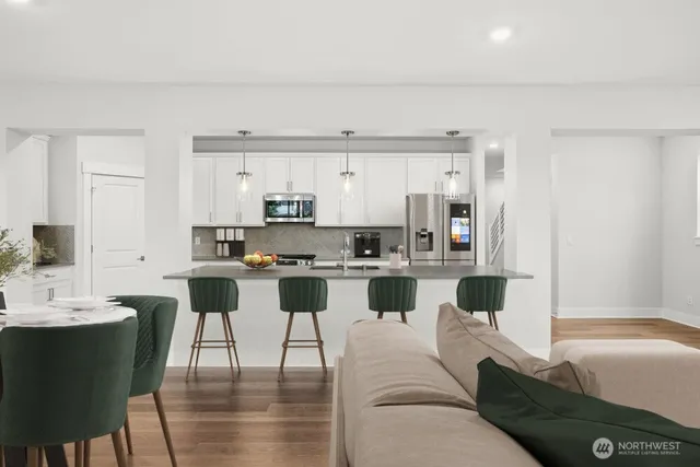 a living room with furniture and a view of kitchen