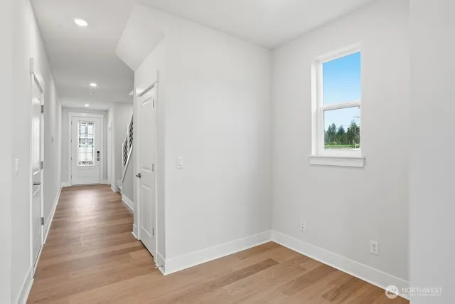 a view of a hallway with wooden floor