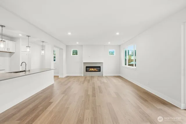 a view of an empty room with a window and fireplace