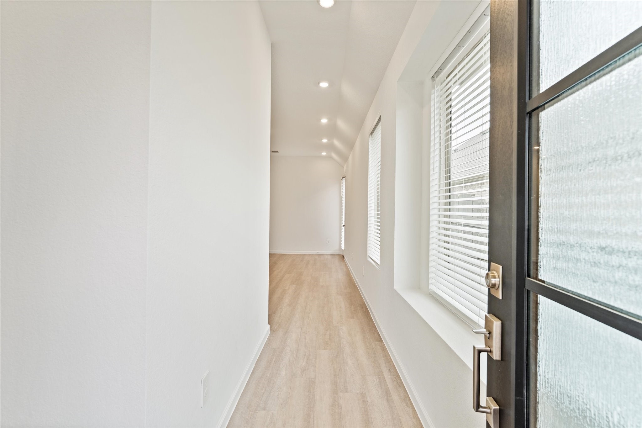 15520 Sunset Maple Court Conroe, TX 77302 - Photo 5 of 46 a view of a hallway with wooden floor and staircase