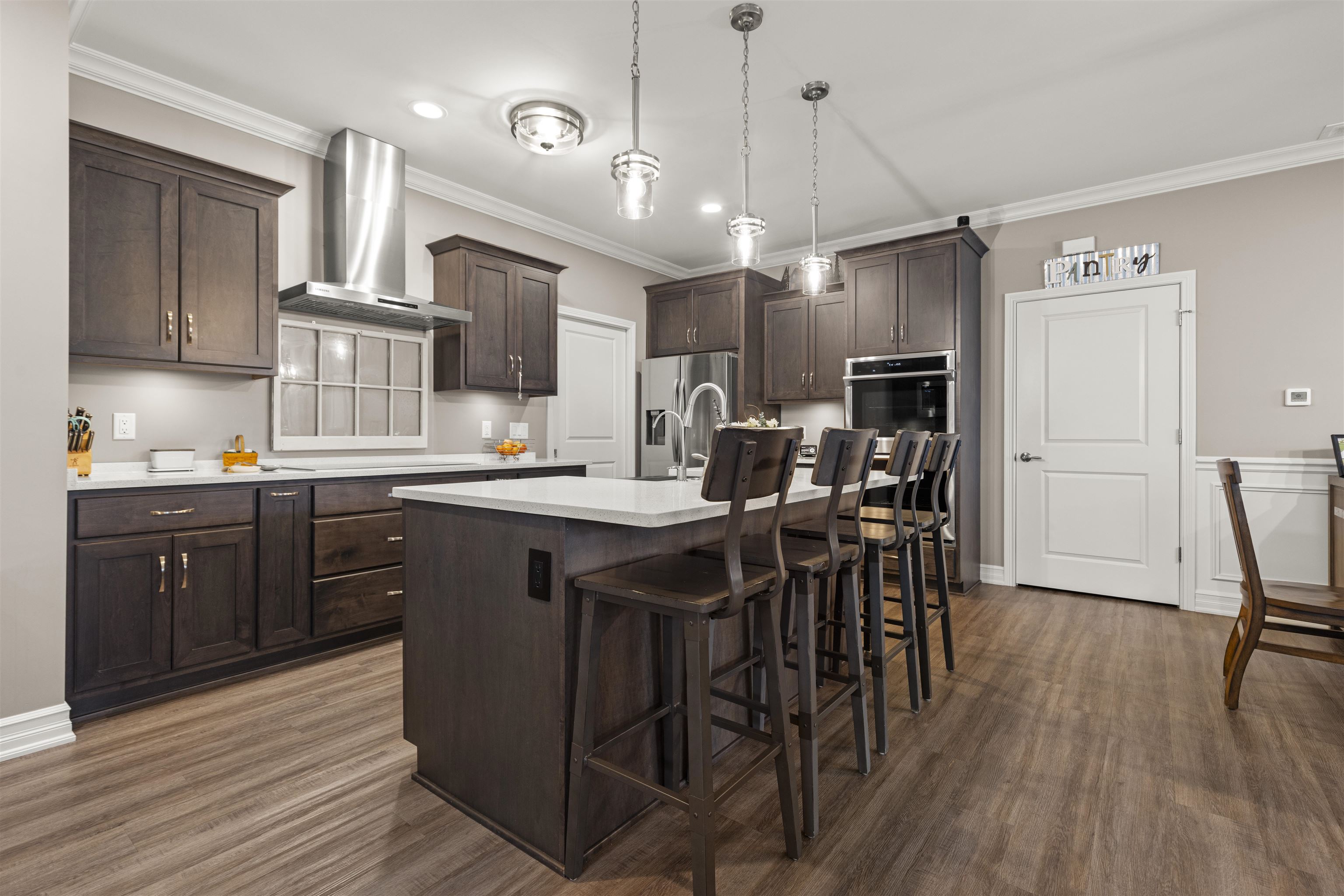 433 Stearn Drive Genoa, IL 60135 - Photo 2 of 24 a kitchen with stainless steel appliances granite countertop wooden floors a stove and a refrigerator
