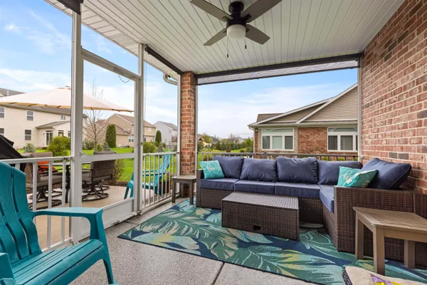 a view of a patio with a table chairs and a yard
