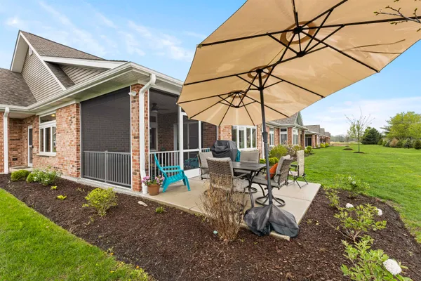 a view of a house with a big yard and large trees