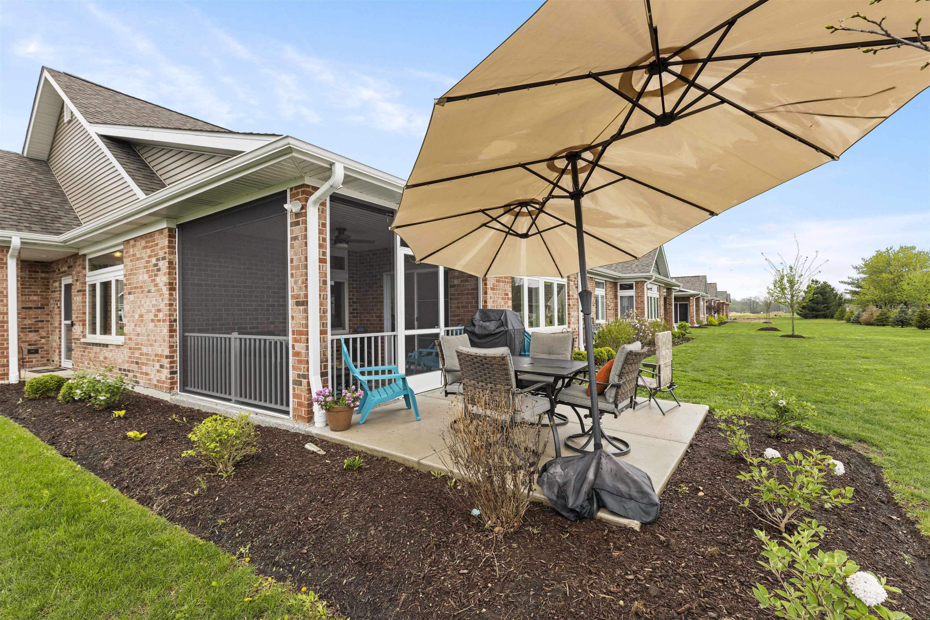 433 Stearn Drive Genoa, IL 60135 - Photo 22 of 24 a view of a patio with a table chairs and a yard