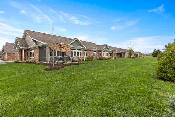 a front view of a house with a garden
