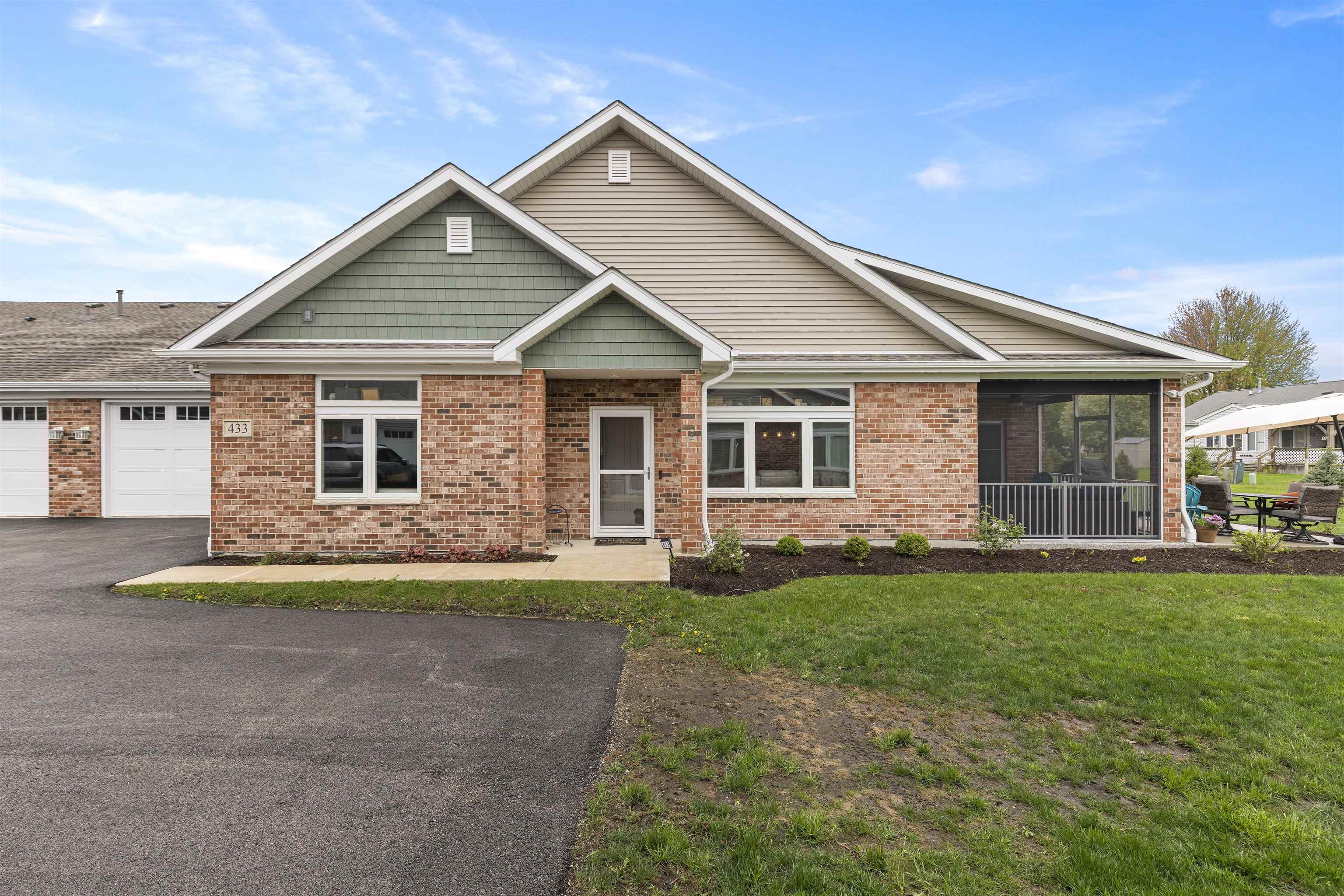 433 Stearn Drive Genoa, IL 60135 - Photo 24 of 24 a front view of a house with a garden