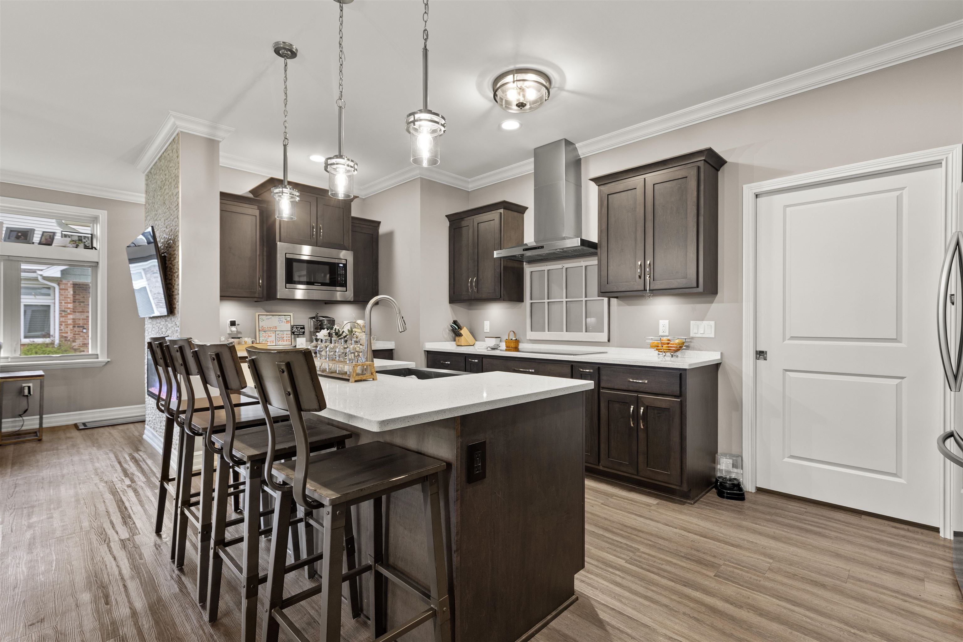 433 Stearn Drive Genoa, IL 60135 - Photo 3 of 24 a kitchen with stainless steel appliances kitchen island granite countertop a sink a stove a dining table and chairs