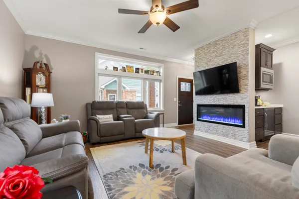 a living room with furniture a flat screen tv and a fireplace