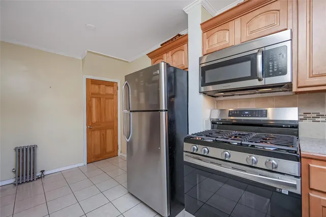 a kitchen with stainless steel appliances granite countertop a refrigerator and a stove top oven