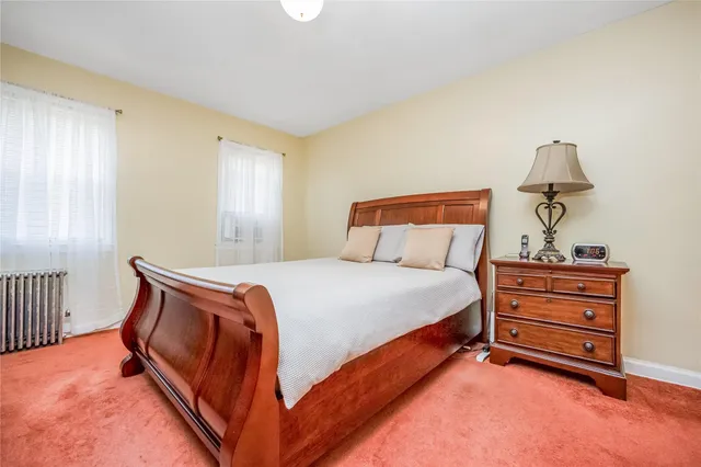 a bedroom with bed and a window