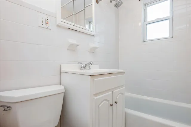 a bathroom with a sink a toilet and bathtub