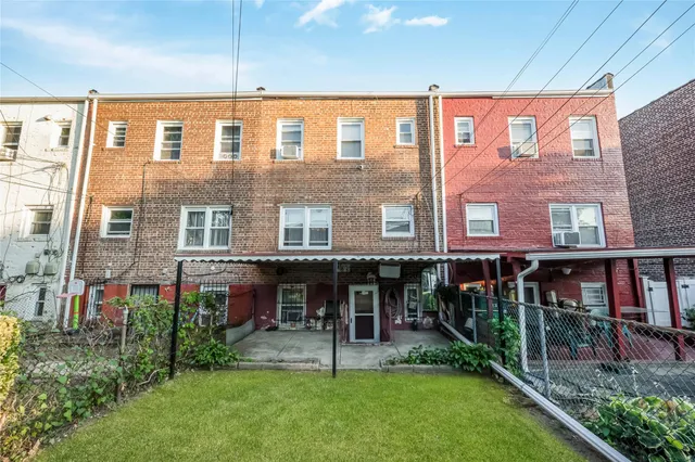a view of a brick building with a yard
