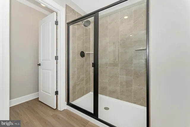 a bathroom with a glass shower door