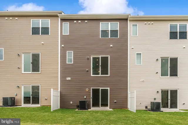 a brick house that has a large windows