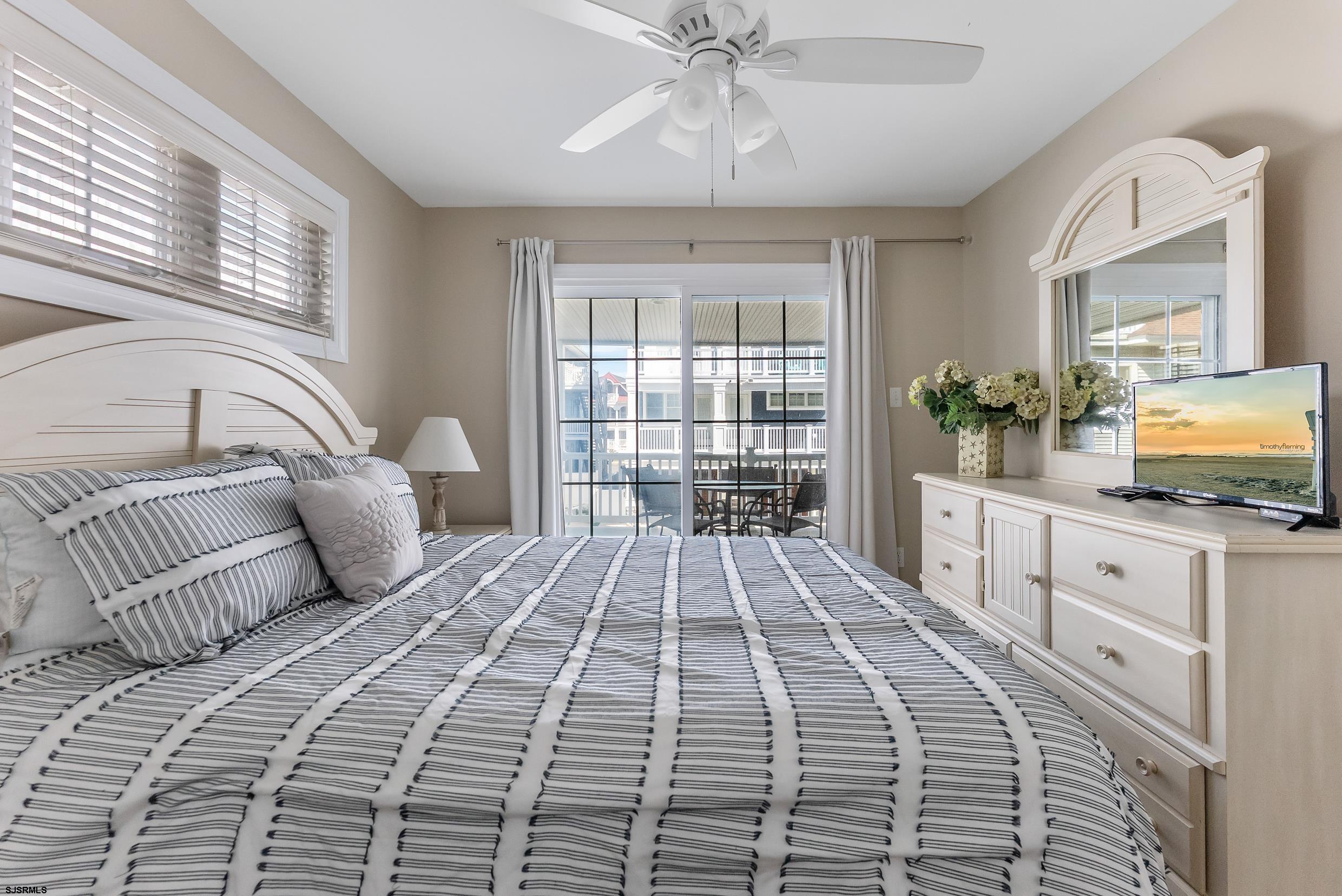 909 East 4th Street Ocean City, NJ 08226 - Photo 11 of 83 a bedroom with a large bed and a large window