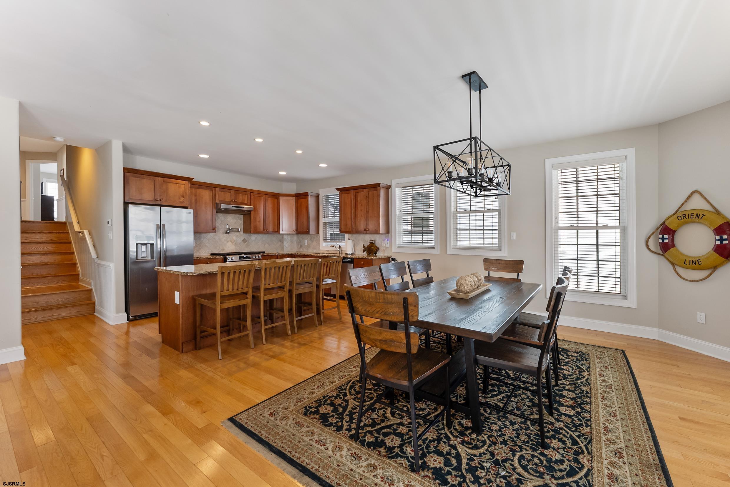 909 East 4th Street Ocean City, NJ 08226 - Photo 19 of 83 a dining room with furniture a rug and a chandelier