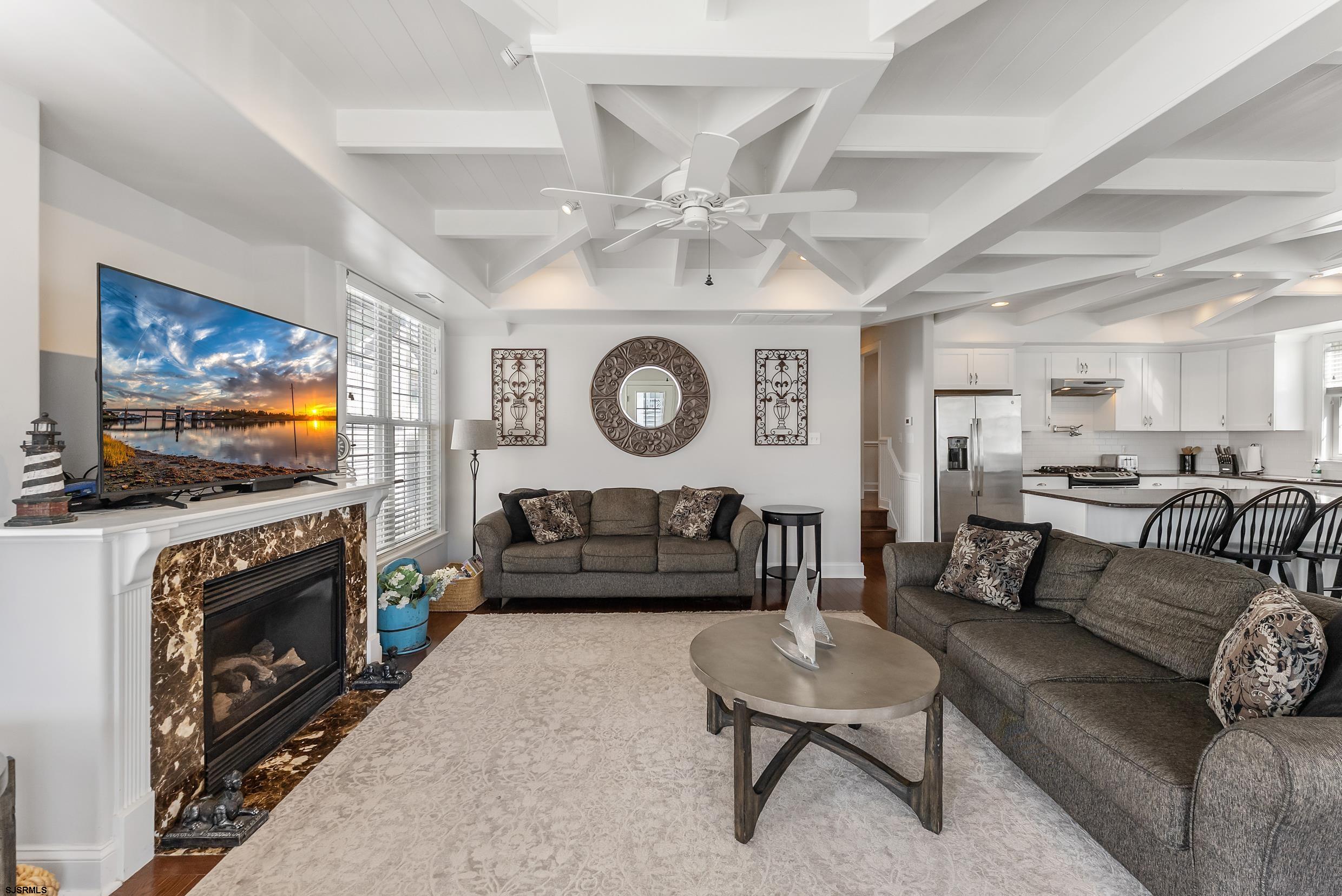 909 East 4th Street Ocean City, NJ 08226 - Photo 44 of 83 a living room with furniture a flat screen tv and a fireplace