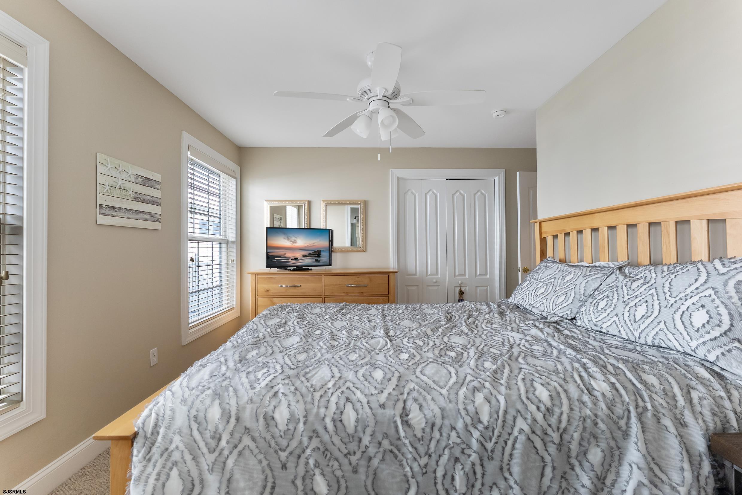 909 East 4th Street Ocean City, NJ 08226 - Photo 5 of 83 a bedroom with a large bed and a window