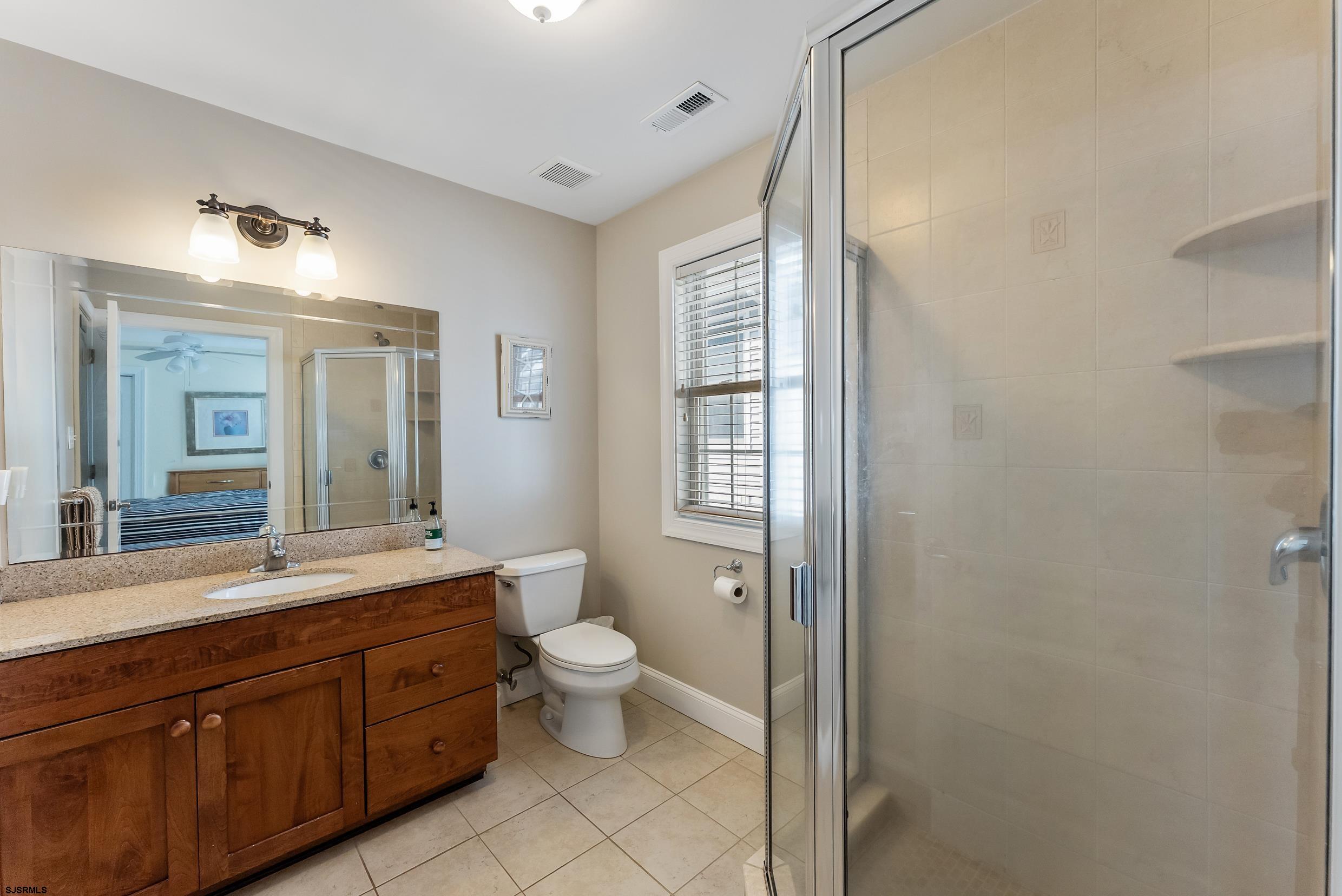 909 East 4th Street Ocean City, NJ 08226 - Photo 54 of 83 a spacious bathroom with a double vanity sink mirror and toilet