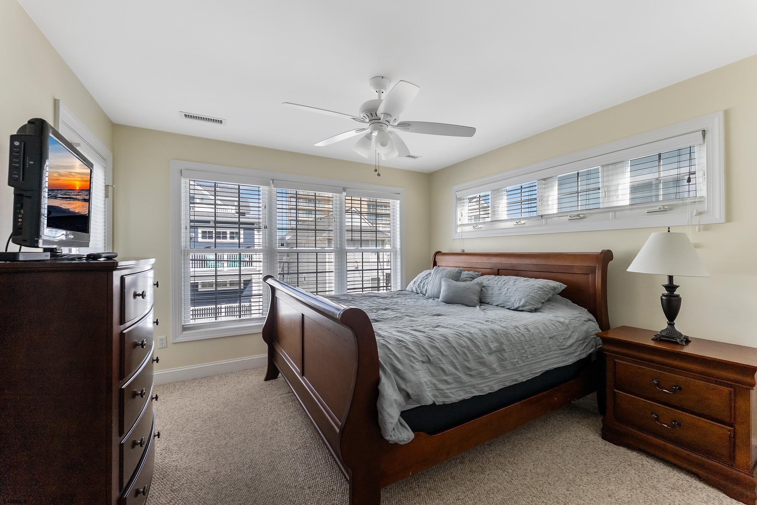 909 East 4th Street Ocean City, NJ 08226 - Photo 55 of 83 a bedroom with a bed and a flat screen tv