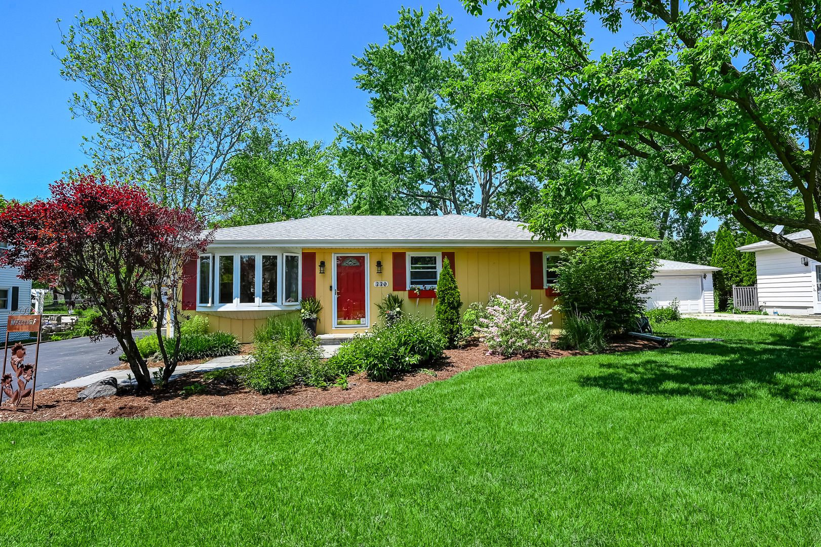 330 Village Road Willowbrook, IL 60527 - Photo 1 of 19 a view of a house with a yard and potted plants