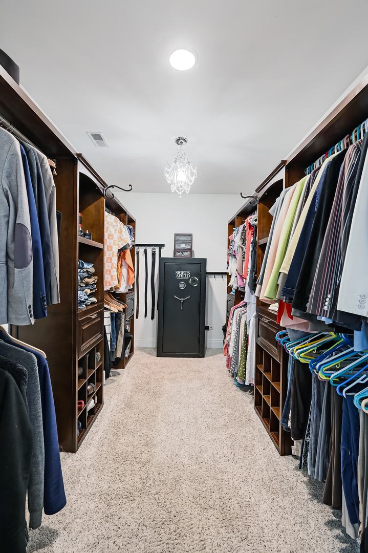 330 Village Road Willowbrook, IL 60527 - Photo 13 of 19 a view of walk in closet with clothes and shoes