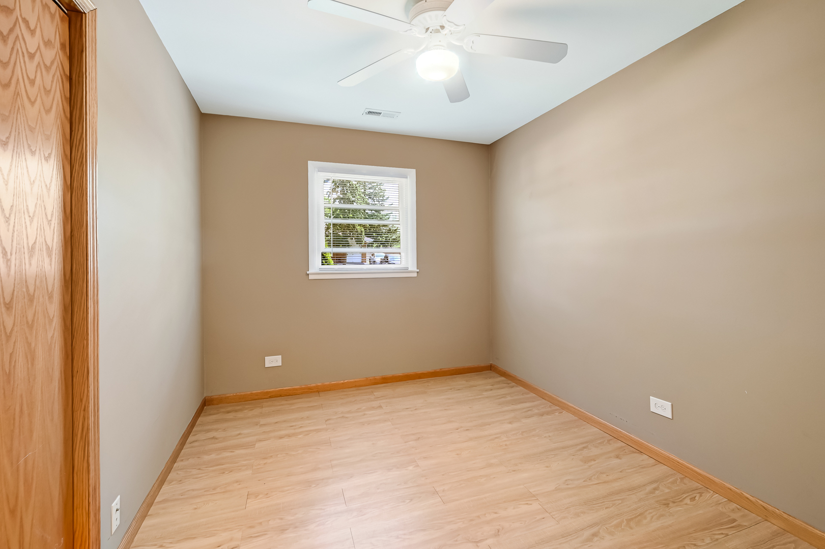 330 Village Road Willowbrook, IL 60527 - Photo 15 of 19 an empty room with a window and a chandelier fan