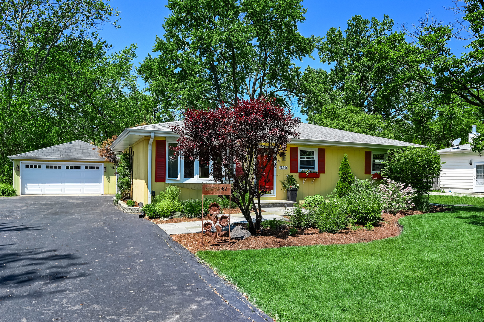 330 Village Road Willowbrook, IL 60527 - Photo 2 of 19 a front view of house with yard and green space