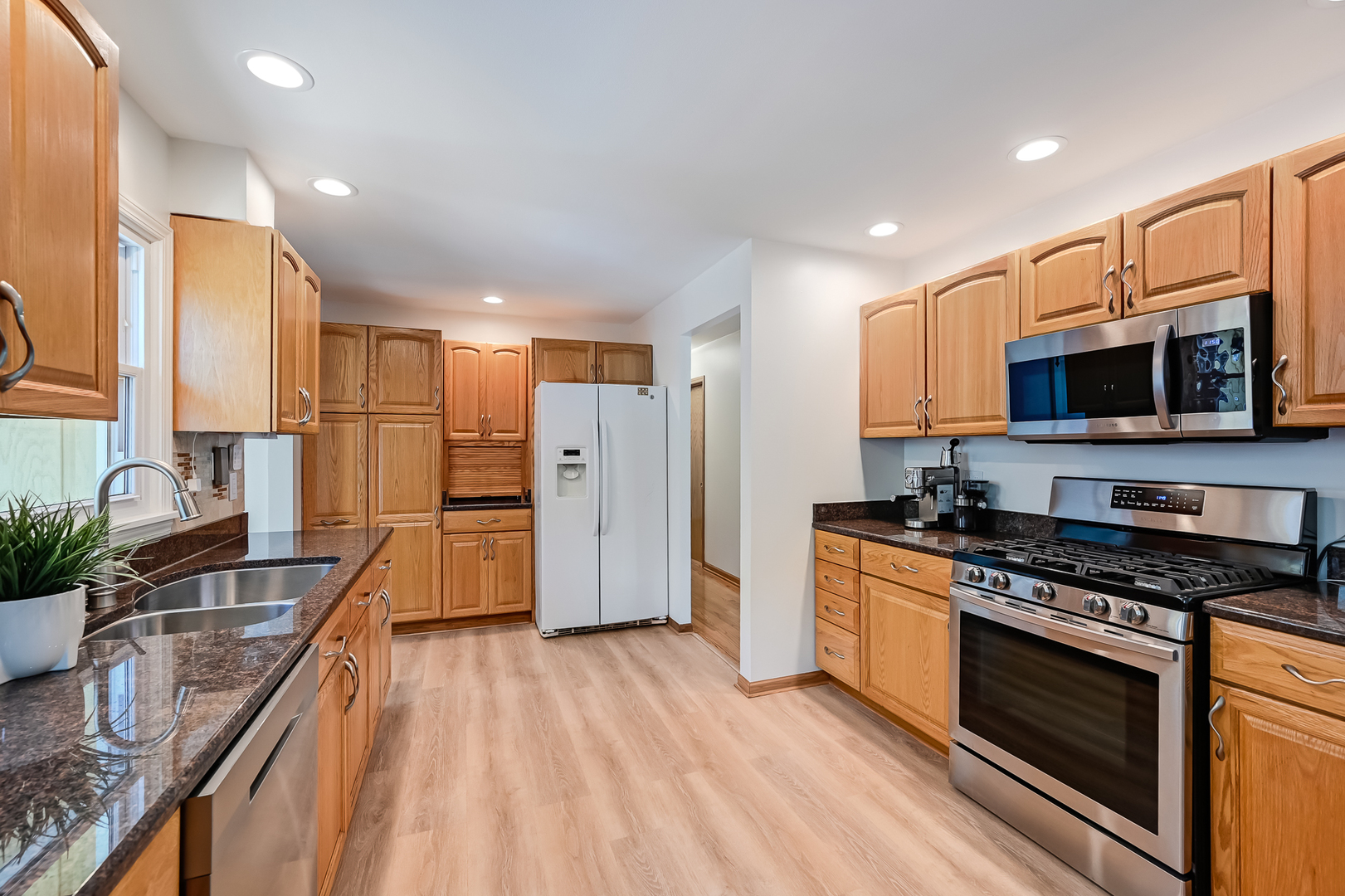 330 Village Road Willowbrook, IL 60527 - Photo 5 of 19 a kitchen with stainless steel appliances a stove sink microwave and cabinets