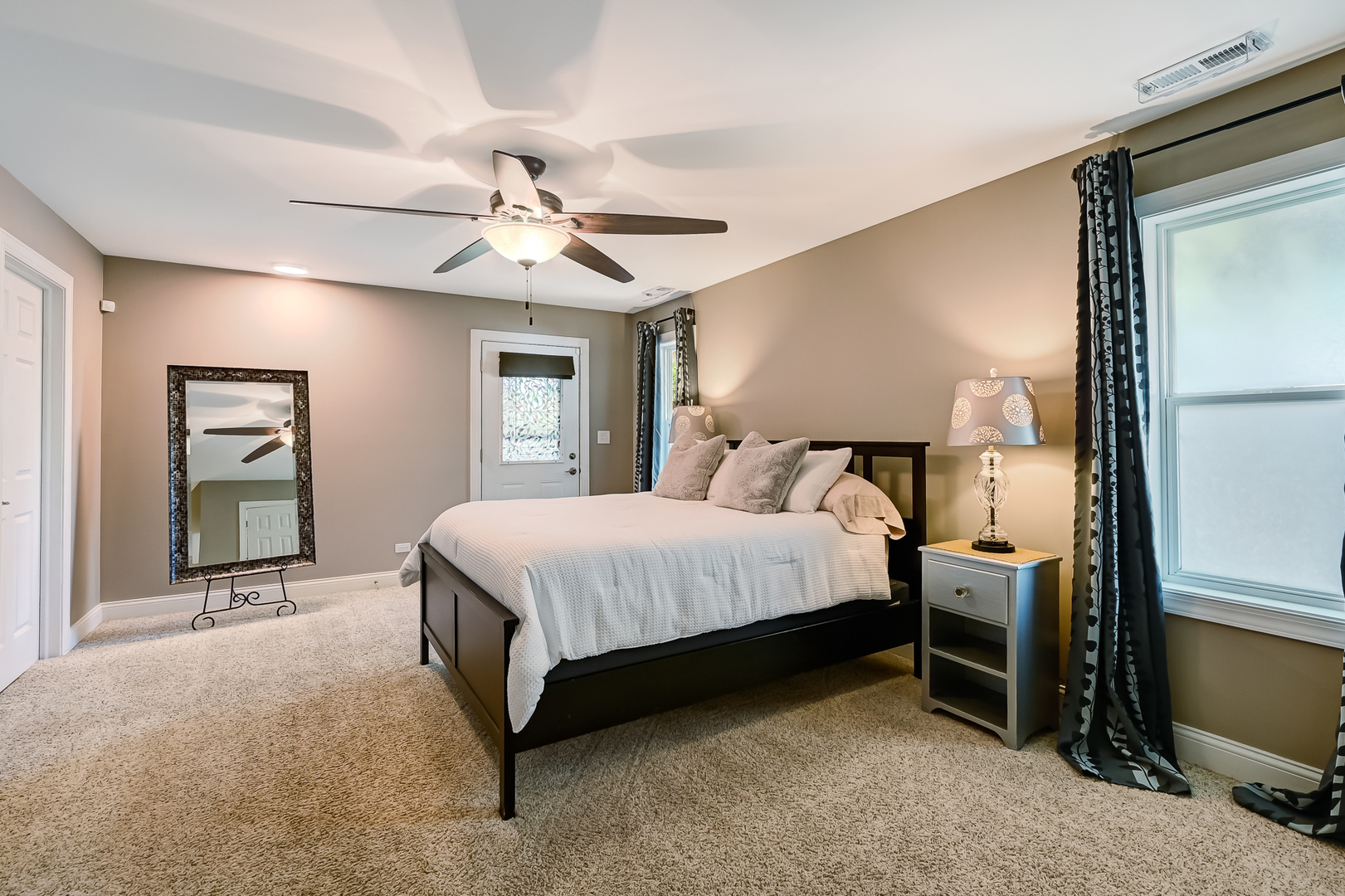 330 Village Road Willowbrook, IL 60527 - Photo 10 of 19 a bedroom with a bed and a chandelier