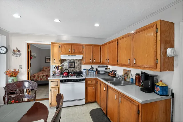 a kitchen with a sink cabinets and window