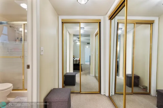 a bathroom with a glass door and a shower