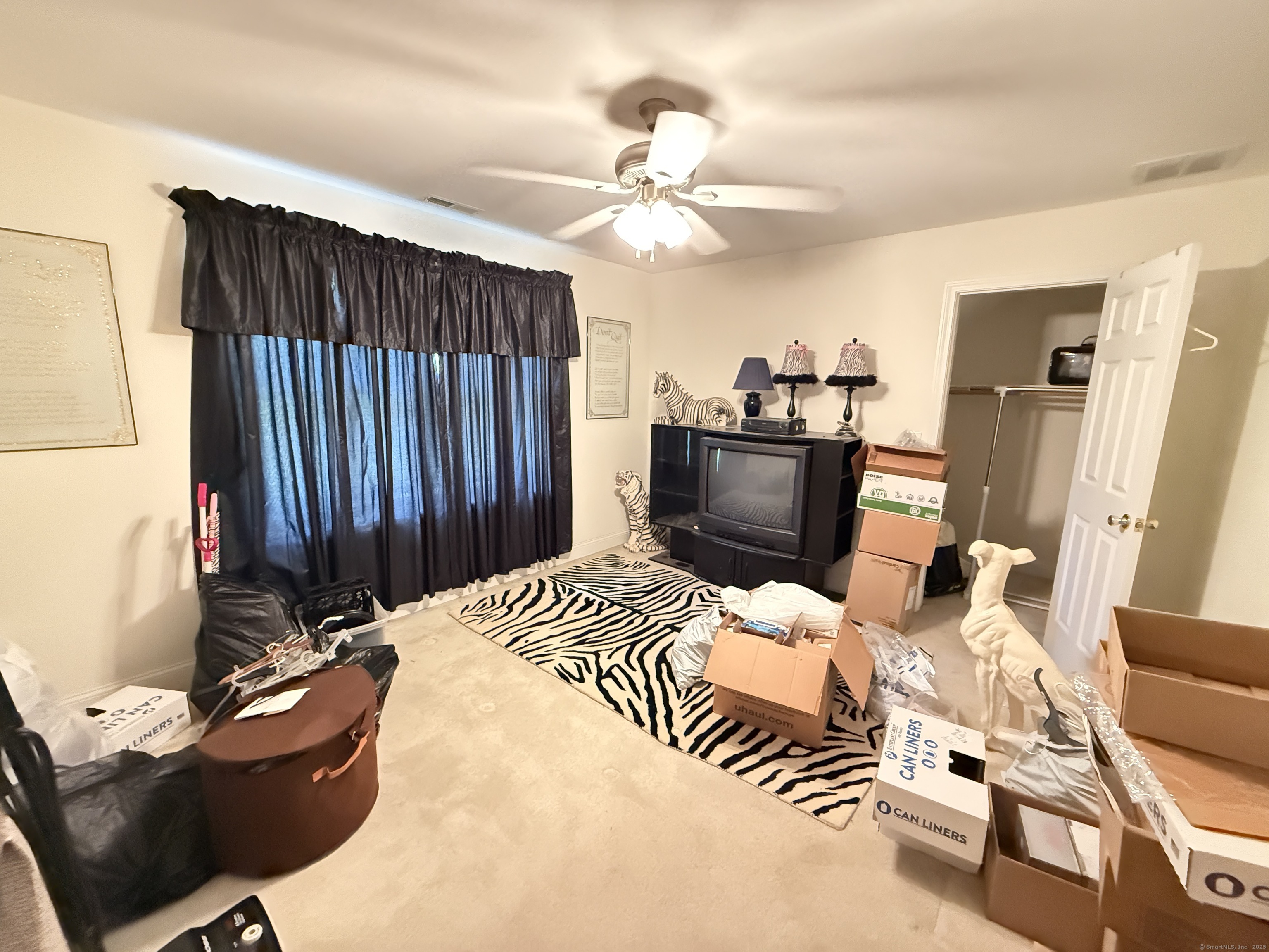 143 Bound Line Road Wolcott, CT 06716 - Photo 11 of 12 a bedroom with a bed and a chandelier