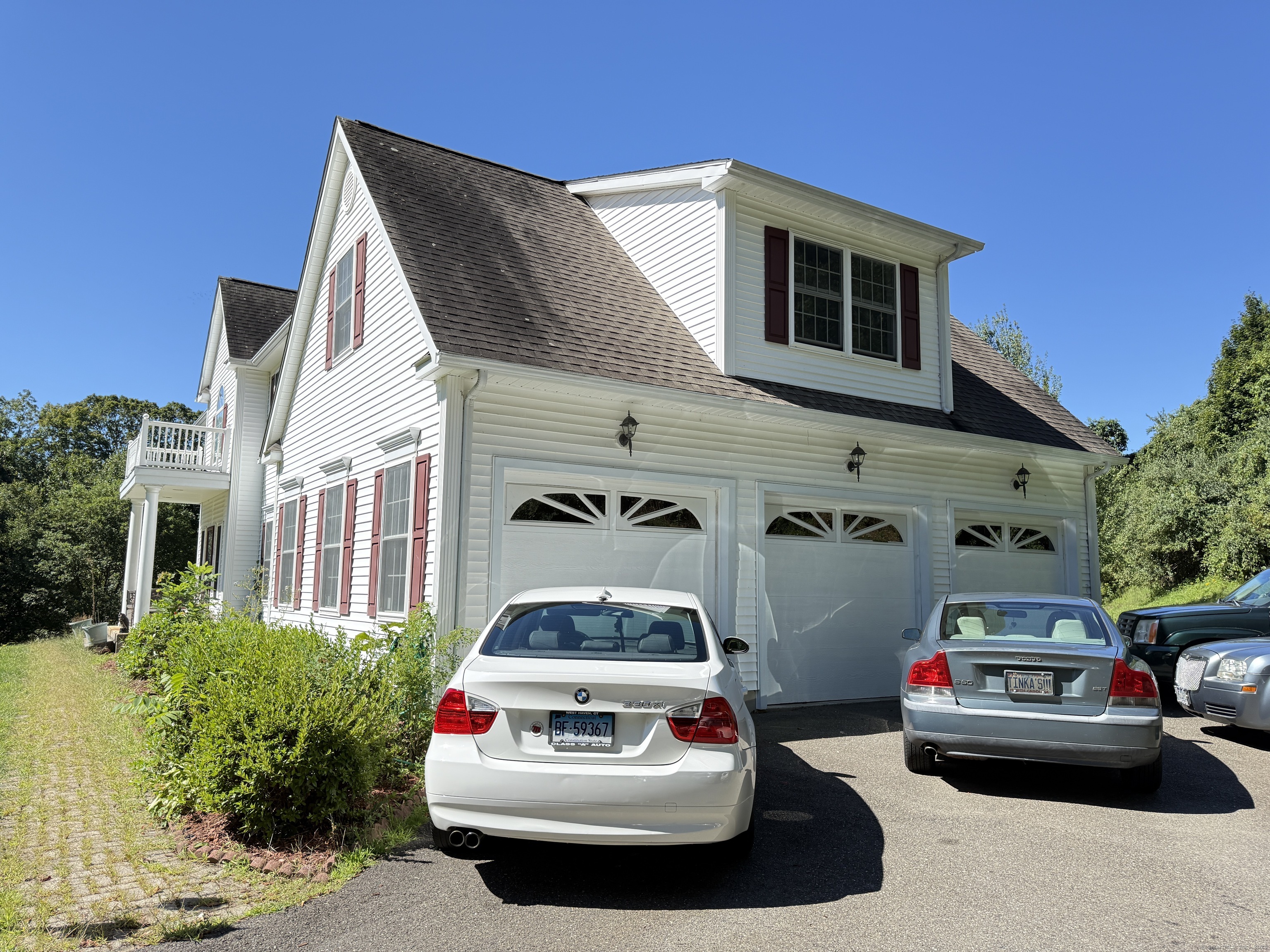 143 Bound Line Road Wolcott, CT 06716 - Photo 4 of 12 a car parked in front of a white house