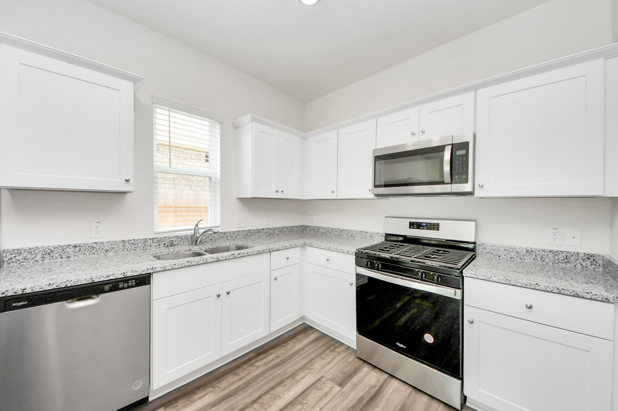 1812 Corsica Crk Lane Rosharon, TX 77583 - Photo 12 of 48 a kitchen with granite countertop a sink and a stove top oven