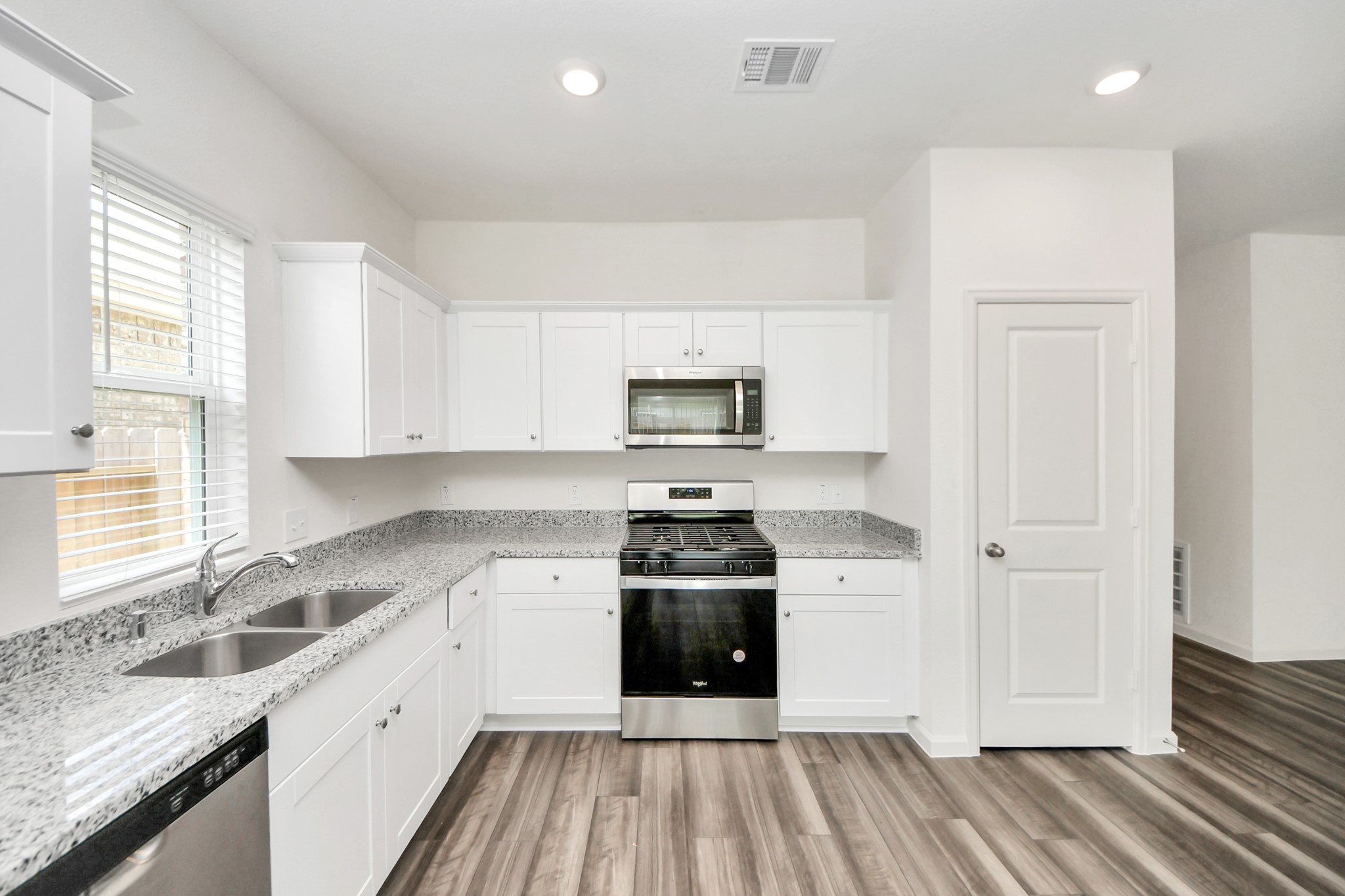1812 Corsica Crk Lane Rosharon, TX 77583 - Photo 13 of 48 a kitchen with a sink stove and cabinets