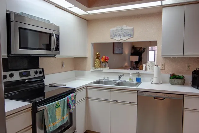 a kitchen with a sink stove and microwave