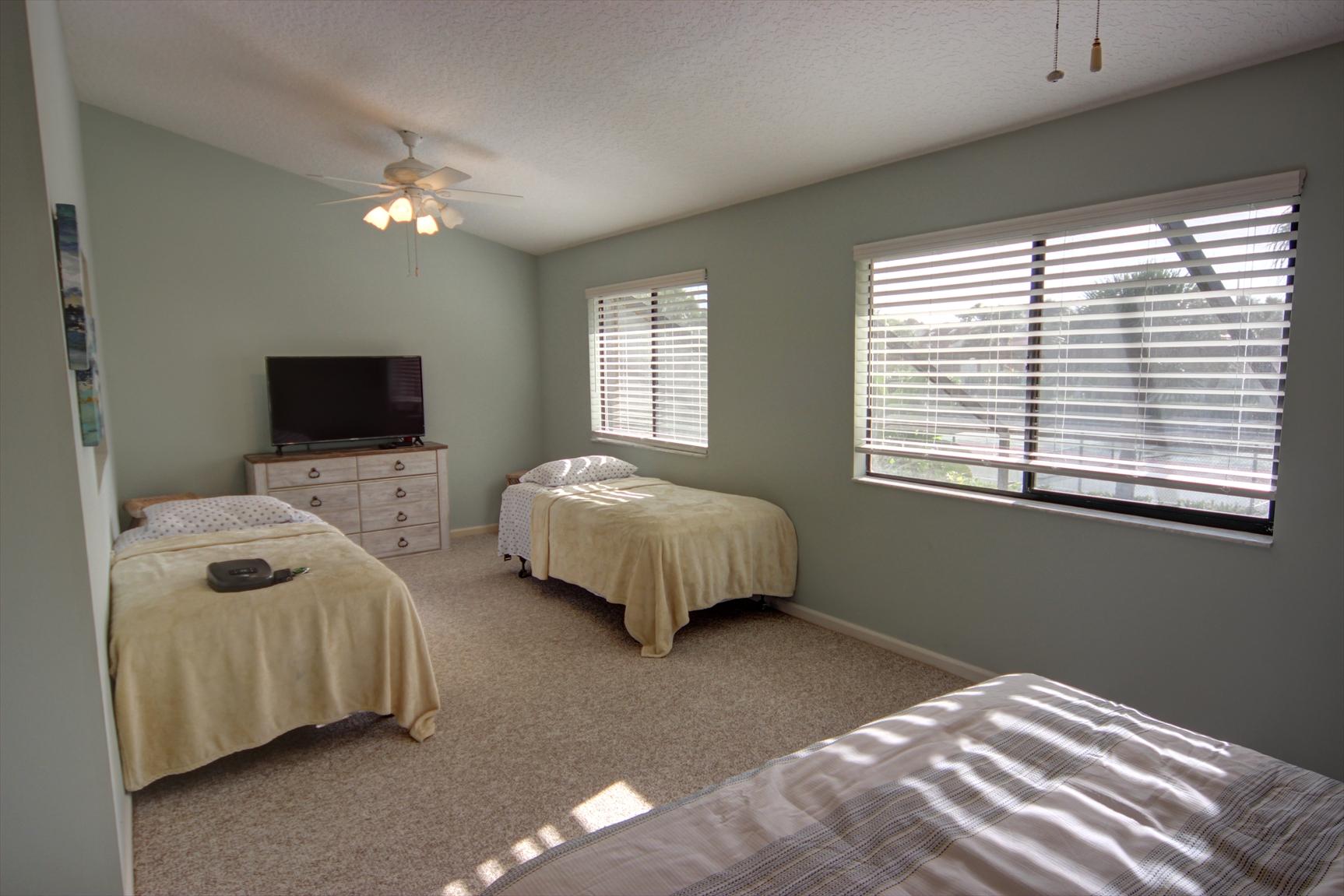 508 Sea Oats Drive, Unit B4 Juno Beach, FL 33408 - Photo 16 of 26 a bedroom with bed tv and window