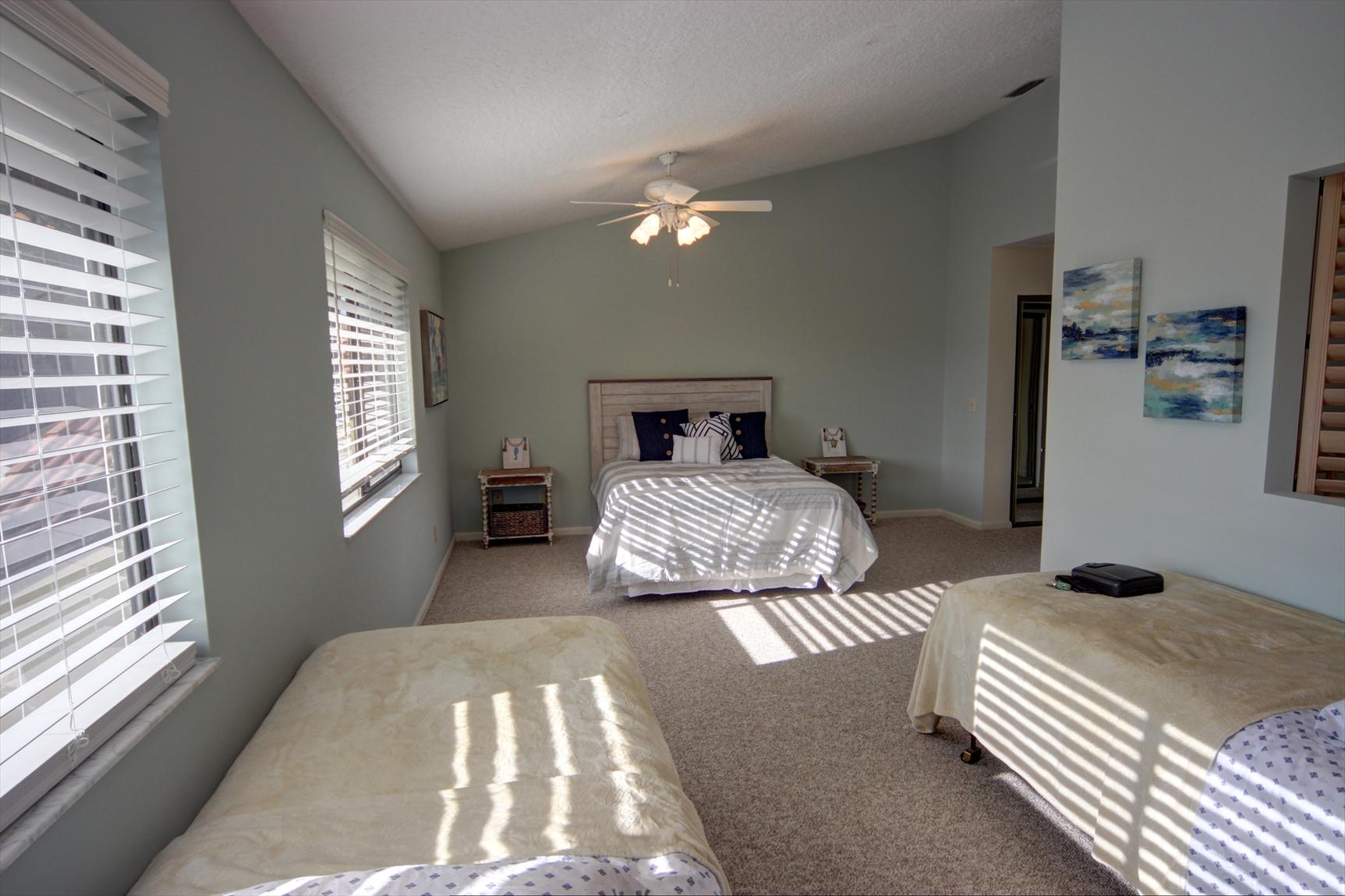 508 Sea Oats Drive, Unit B4 Juno Beach, FL 33408 - Photo 17 of 26 a bedroom with a large bed and a chandelier
