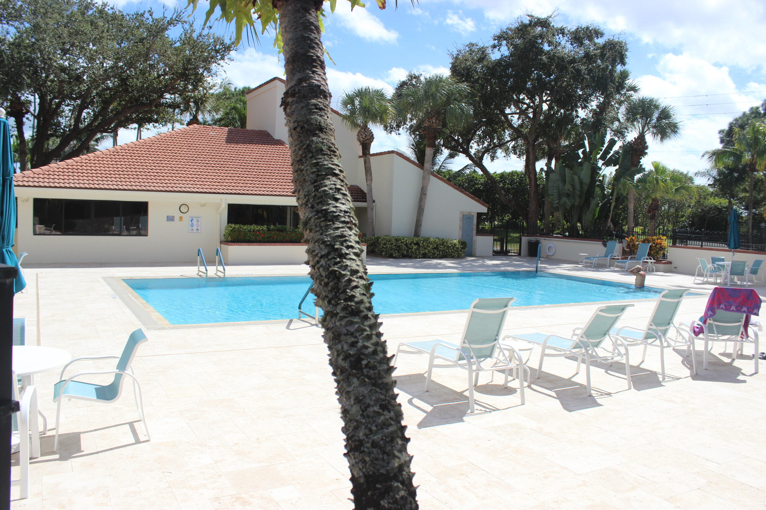 508 Sea Oats Drive, Unit B4 Juno Beach, FL 33408 - Photo 23 of 26 a swimming pool with outdoor seating and yard