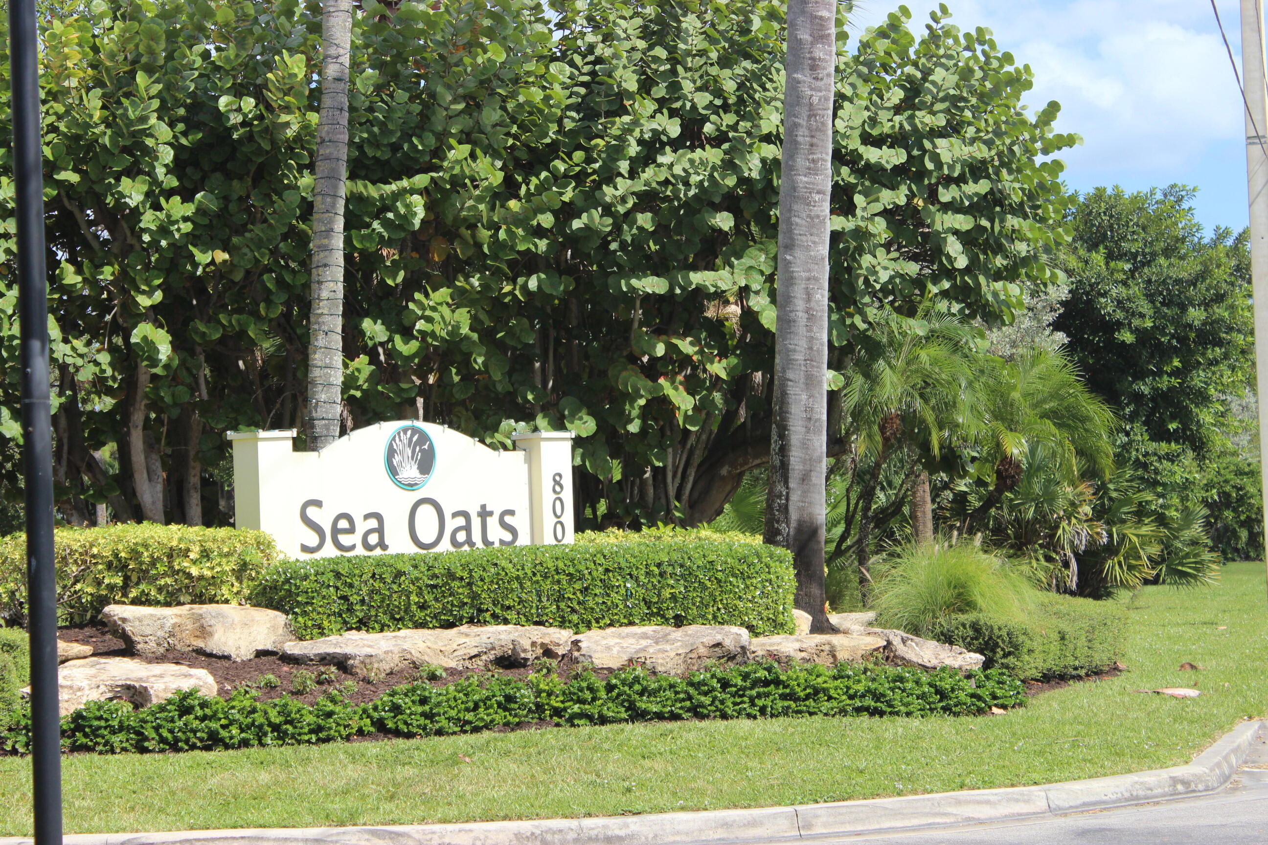 508 Sea Oats Drive, Unit B4 Juno Beach, FL 33408 - Photo 24 of 26 a sign board with tall trees