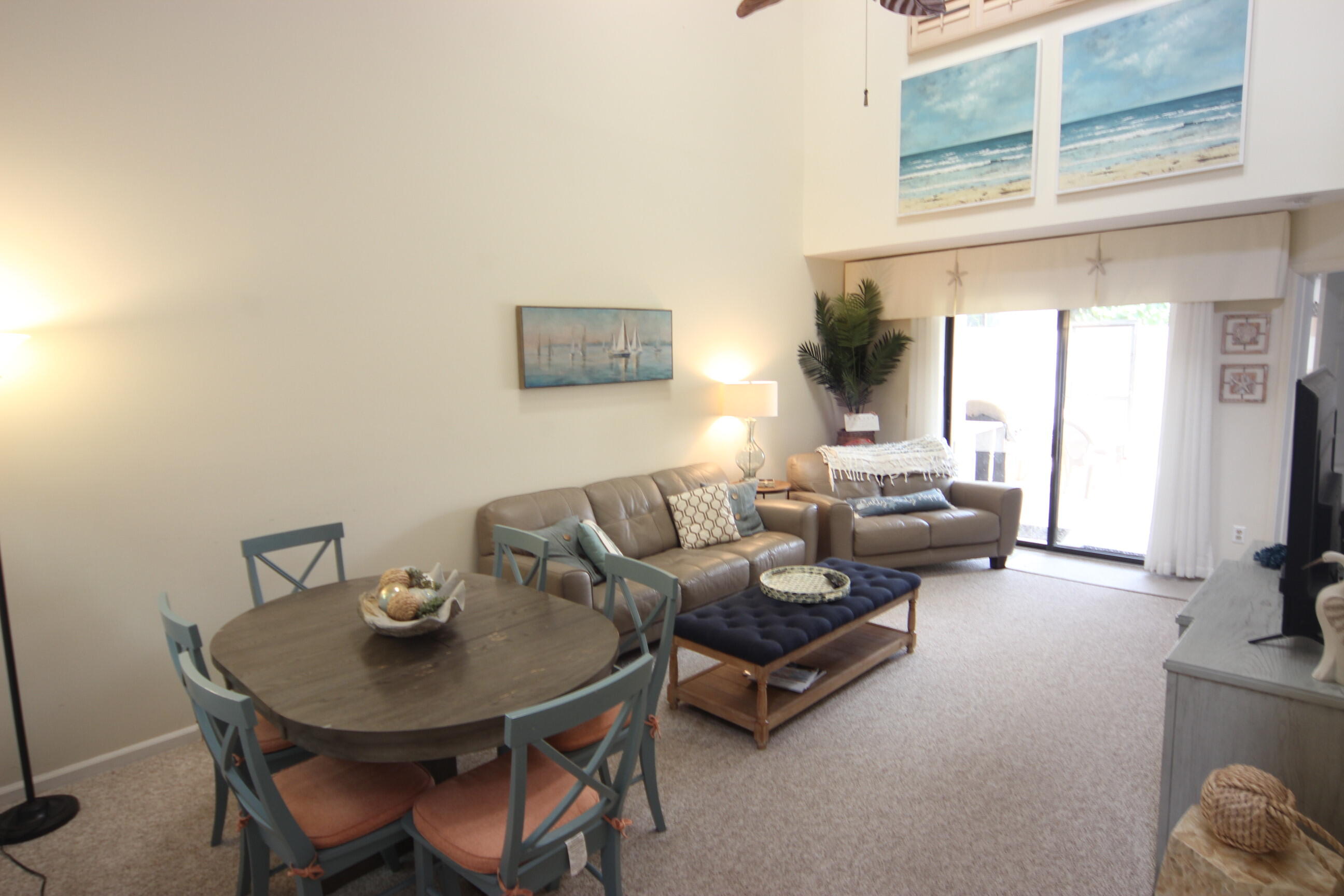 508 Sea Oats Drive, Unit B4 Juno Beach, FL 33408 - Photo 4 of 26 a living room with furniture and a flat screen tv