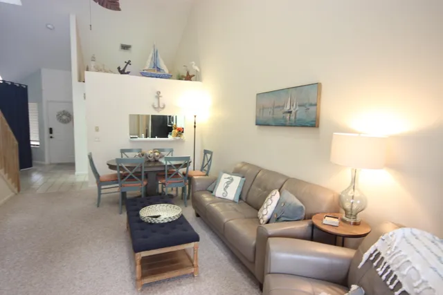 a living room with furniture and a lamp