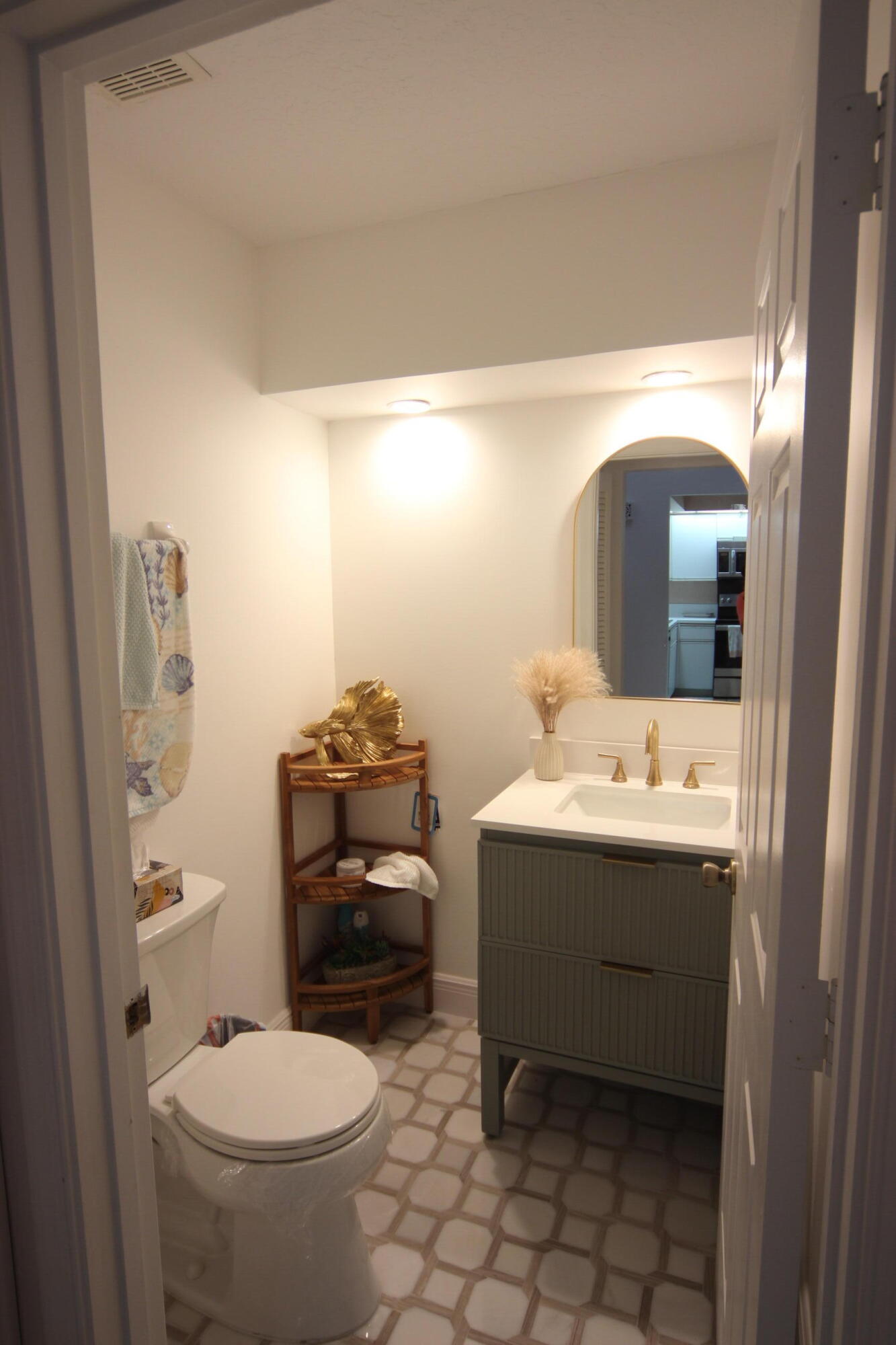 508 Sea Oats Drive, Unit B4 Juno Beach, FL 33408 - Photo 9 of 26 a bathroom with a sink toilet and mirror