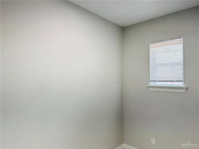 an empty room with window and traffic signal