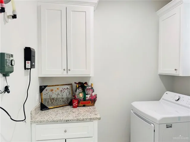 a bathroom with a granite countertop toilet sink and mirror