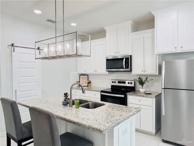 a view of a dining room with furniture a chandelier and wooden floor
